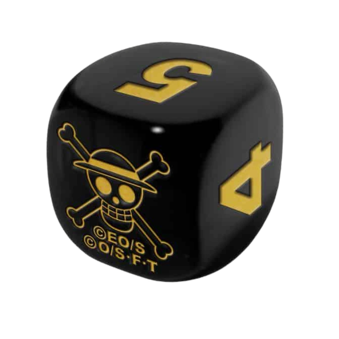 Dado da gioco nero con simboli dorati del One Piece Card Game, incluso nel set celebrativo.